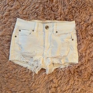 American eagle white jean shorts with rips.